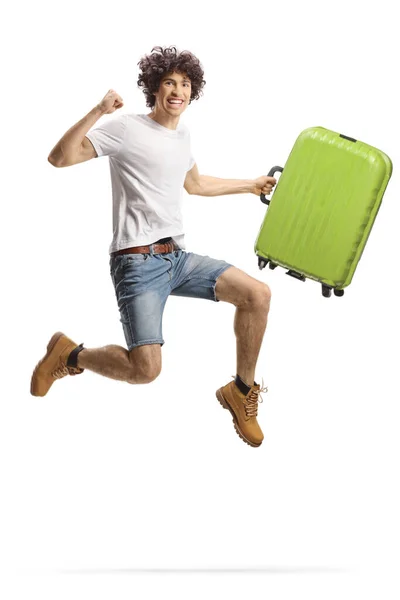 興奮した若いです男保持スーツケースとジャンプ孤立した上に白の背景 — ストック写真