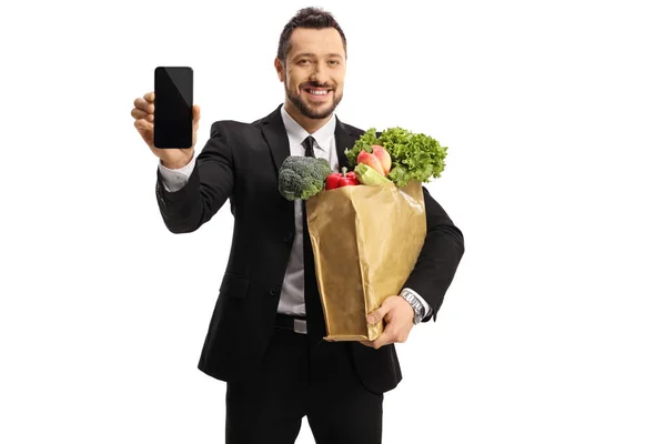 Zakenman Met Een Zak Boodschappen Een Smartphone Geïsoleerd Witte Achtergrond — Stockfoto