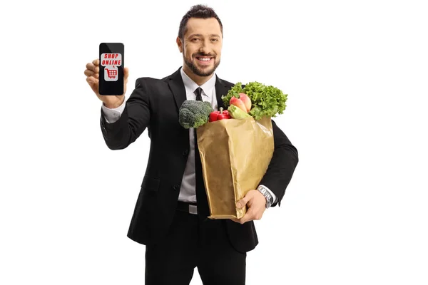 Empresario Con Una Bolsa Comestibles Que Muestra Teléfono Inteligente Aislado —  Fotos de Stock