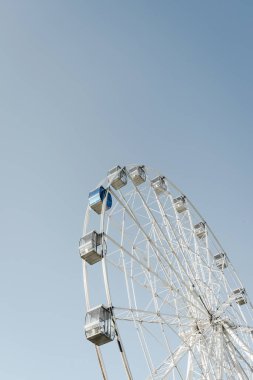 Mavi gökyüzü arka planındaki lunaparkın dönme dolabı. Volgograd, Rusya.