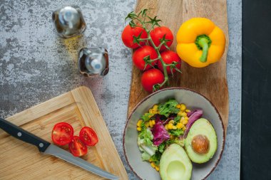 Bir tabak sebze ve avokado salatası, zeytinyağı ve şarap sirkesi. Sağlıklı yiyecekler. Vejetaryen. Domates ve yeşil salata. Organik ürünler. Çevre. Ev.