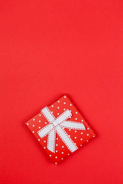 Caja de regalo roja con un lazo sobre un fondo rojo. Día de San Valentín. —  Fotos de Stock