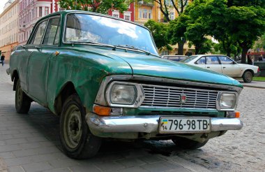 Green Moskvitch car parked in central Lviv, Ukraine. This old Russian car is either a Moskvitch 408 or Moskvitch 412 (same body different engine) and made by Russian carmaker AZLK.