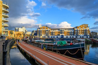 Limehouse, Londra, İngiltere: Limehouse Havzası 'nın akşam manzarası, Doğu Londra' nın rıhtım bölgesinde bir marina. Tekneler ve mavnalar rıhtımda demirli ve bir sürü modern daire var.. 