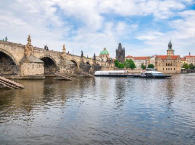 Prague, Czech Republic - June 2022: View with the Charles Bridge main touristic attraction . Medieval stone arch bridge over Vltava river in Prague