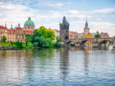 Prague, Czech Republic - June 2022: View with the Charles Bridge main touristic attraction . Medieval stone arch bridge over Vltava river in Prague