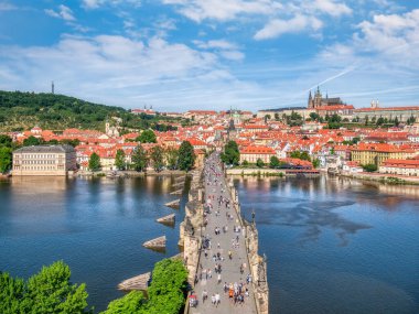 Prague, Czech Republic - June 2022: View from above with the Charles Bridge main touristic attraction with the Prague Castle in the background