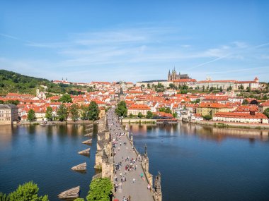 Prague, Czech Republic - June 2022: View from above with the Charles Bridge main touristic attraction with the Prague Castle in the background