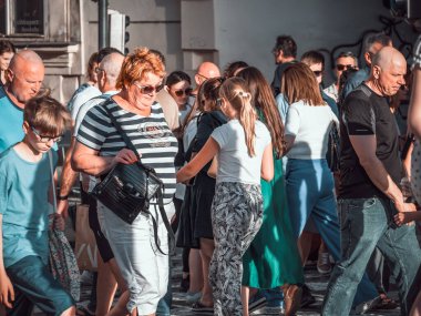 Prague, Czech Republic - June 2022: Crowds of tourist people walking and strolling on the famous Charles Bridge in Prague.