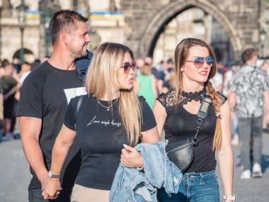 Prague, Czech Republic - June 2022: Crowds of tourist people walking and strolling on the famous Charles Bridge in Prague.