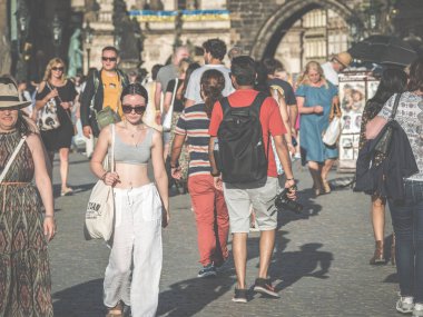 Prague, Czech Republic - June 2022: Crowds of tourist people walking and strolling on the famous Charles Bridge in Prague.