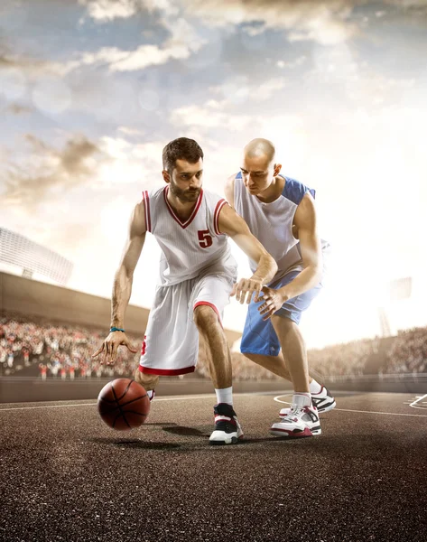 Basketball player in action on background of sky and crowd — Stock Photo, Image