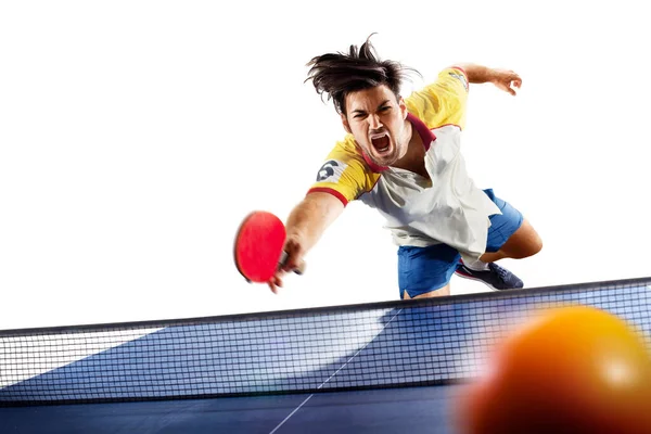 young sports man tennis player is playing on light background