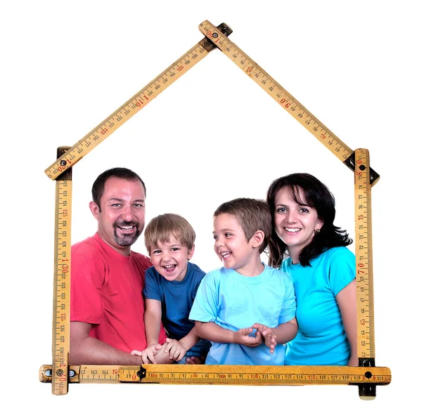 Family forms meter stick into a house shape — Stock Photo, Image