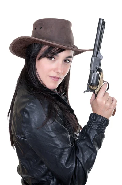 Beautiful brunette cowgirl model holding a gun — Stock Photo, Image