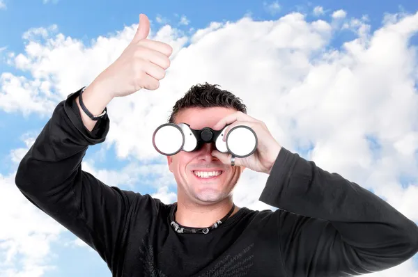 Young man with binoculars — Stock Photo, Image