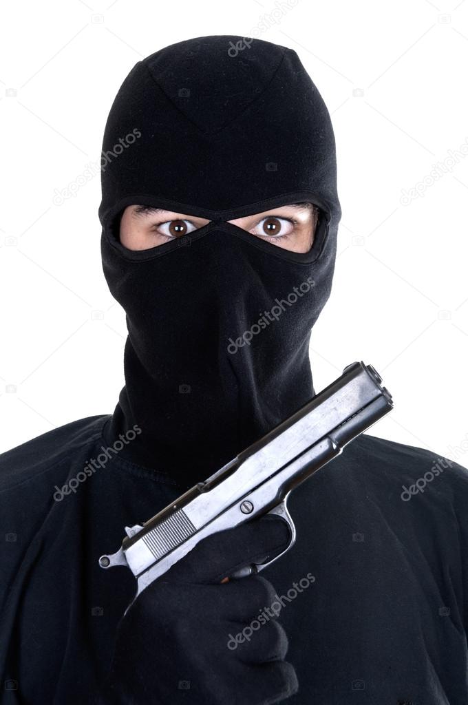 Masked man aims with gun 