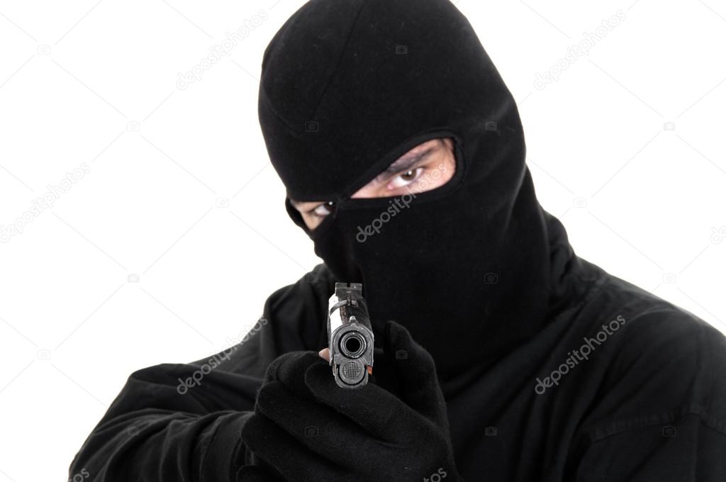 Masked man aims with gun 