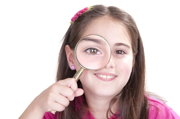 Curious little girl is looking through magnifying glass — Stock Photo, Image