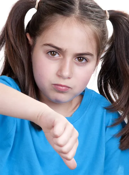 Little girl showing thumbs up against white background — Stock Photo, Image