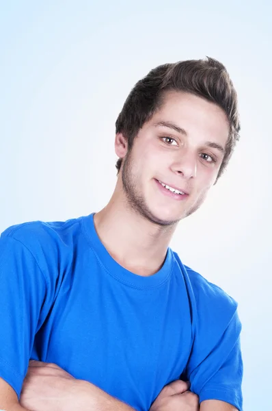 Teenage boy smiling with arms crossed — Stock Photo, Image