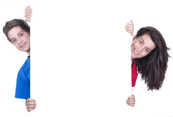 Two teenagers holding at a blank board — Stock Photo, Image