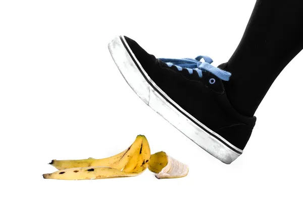 Foot, shoe about to slip on banana peel — Stock Photo, Image