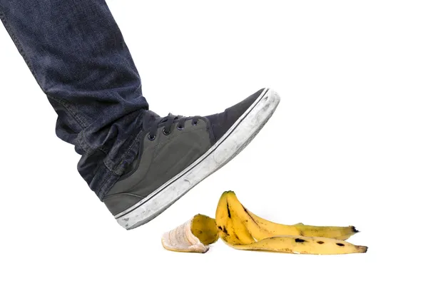 Foot, shoe about to slip on banana peel — Stock Photo, Image