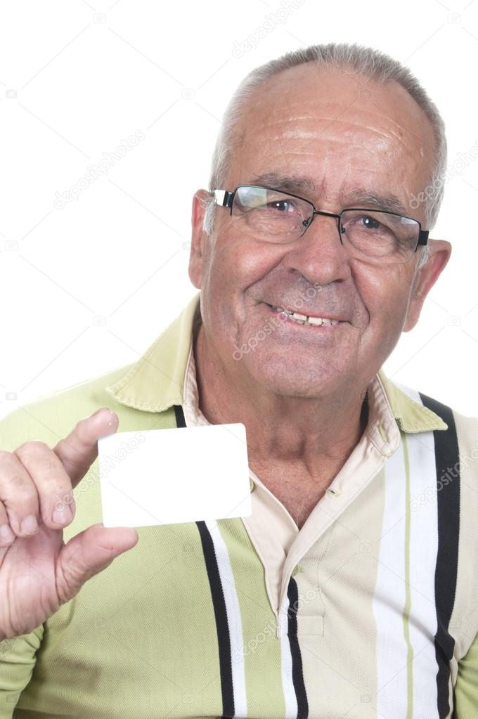 Smiling old man holding up a cash card. 