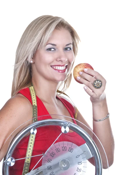 Blonde with weigh and red apple — Stock Photo, Image