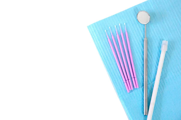 Dental instruments, microbrushes lie on a white table on a napkin. Care and prevention concept. Blank space for an inscription. — Stock Photo, Image