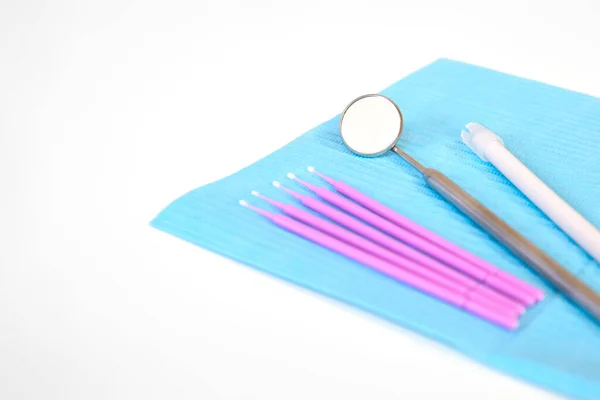 Dental instruments, microbrushes lie on a white table on a napkin. Care and prevention concept. Space for text. — Stock Photo, Image