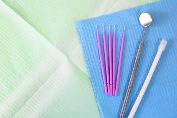 Dental instruments, microbrushes lie on a napkin. Tooth care and prevention concept. Blank space for an inscription. — Stock Photo, Image
