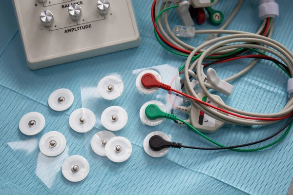 Perangkat untuk stimulasi neuromuskular dari sambungan temporomandibular dengan kabel dan elektroda di atas meja Stok Gambar Bebas Royalti
