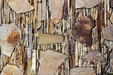 Kahverengi renkli taş duvar fayanslarının desenli fotoğrafı.