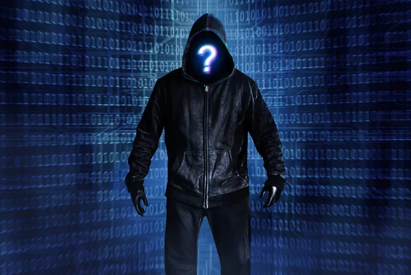 Photo of hacker person in black hood and clothing on digital binary code background.