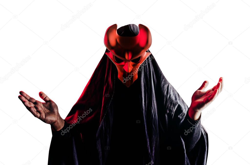 Isolated scary horror occult sectarian priest in black hood and metal mask on white background.