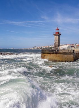 lighthouse at Atlantic ocean with big wave