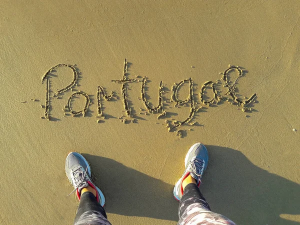 Portugal text in the sand written by hand. feet from above on a beach — 스톡 사진