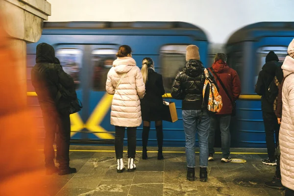 Subway station in KievVarious people stand at metro station,waiting for their train to ride-web,city life scene,social story concept. Subway station in Kiev