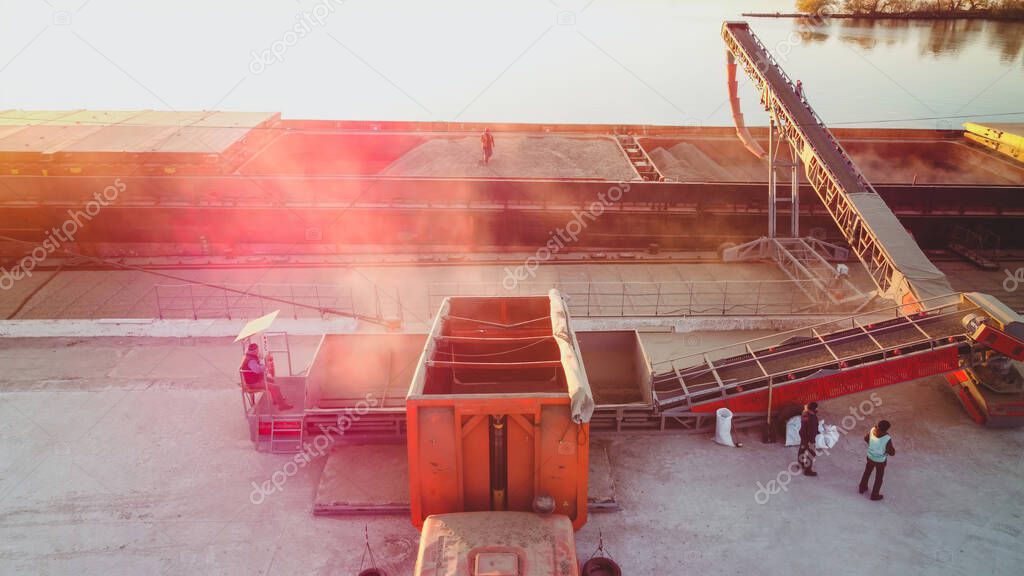 Grain loading to cargo ship. Port grain elevator. Industrial sea trading port bulk cargo zone grain terminal Ukraine