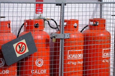 Propane gas cylinders for recreational use in safe locked compound.
