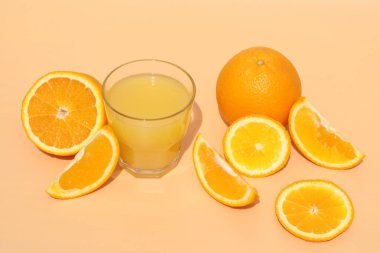 fresh bright orange juice with oranges on yellow background