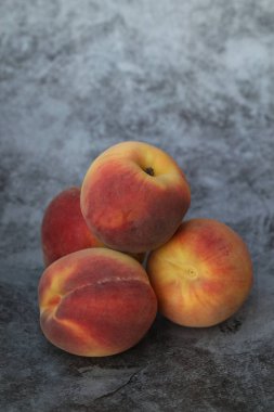  peaches on the grey background with copy space