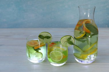 cold citrus lemonade with ice, lemon, mint, lime and orange