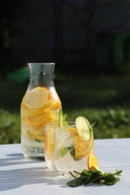 cold citrus lemonade with ice, lemon, mint, lime and orange