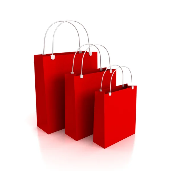 Tre shopping bag su sfondo bianco con riflesso — Foto Stock