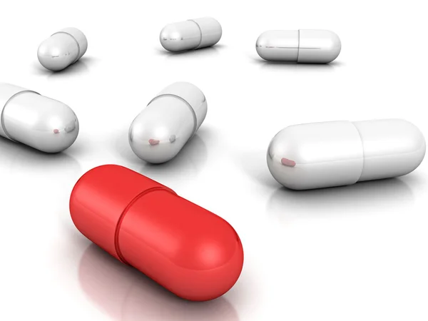 Білі медичні таблетки з червоним — стокове фото