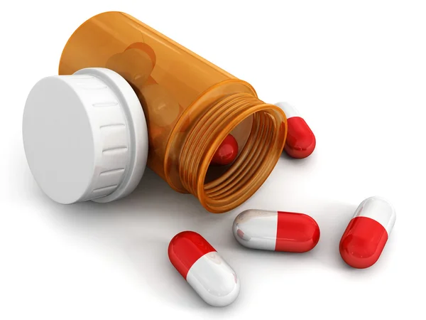 Red medical pills an orange bottle — Stock Photo, Image