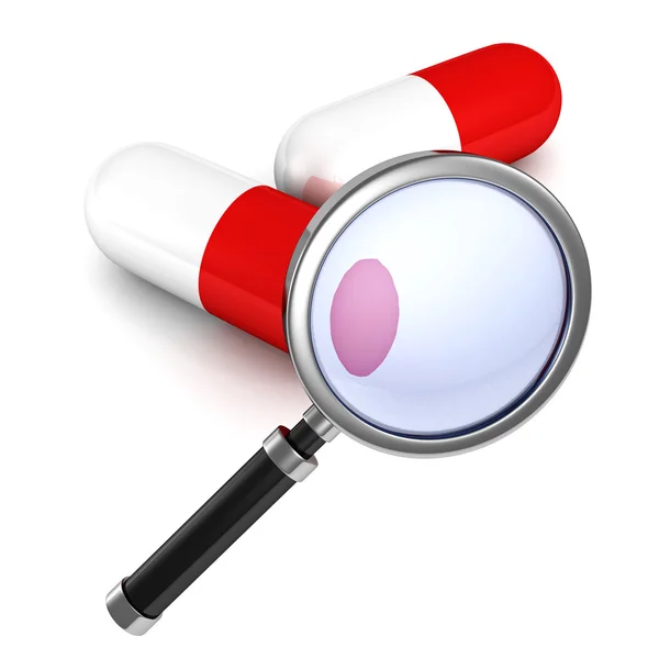 Magnifying glass and red medical pills — Stock Photo, Image